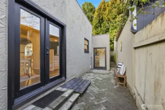 The door seen in the middle of this photo is just outside the primary suite. The long narrow space to the right of this door provides a perfect place to set up a ladder and access the roof.