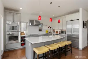 Kitchen with custom island, steam over and induction cooktop.