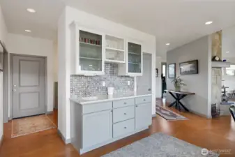 Built in coffee bar with extra prep sink and glass front cabinets.