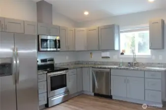 KITCHEN BOASTS EASY CLOSE CABINETRY AND QUARTZ COUNTERTOPS!