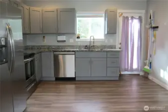 THE OPEN CONCET LIVING AREA HAS A DESIGNATED AREA FOR A DINING ROOM!