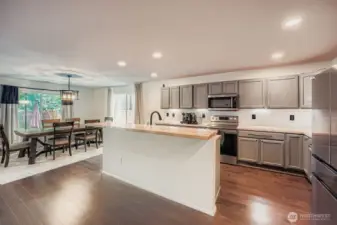 Kitchen area opening to dining area and living space