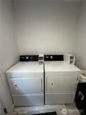 coin-op dryers in shared laundry room