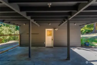 Spacious two-car carport with additional driveway parking.