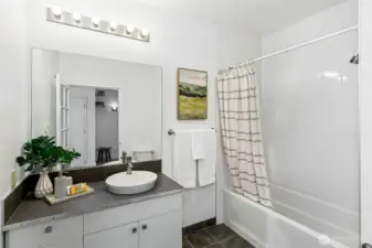 Large bathroom with tub and extra storage.