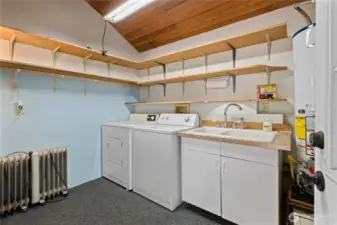 Utility room with sink & propane hot water heater.