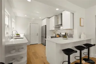 Bright kitchen with quartz countertops, soft-close cabinets, and new stainless steel appliances