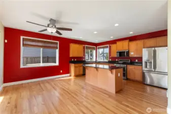 This beautifully designed kitchen features granite countertops and matching backsplash, pantry, and an abundance of cabinet and counter space. Enjoy cooking with stainless steel appliances, including a gas range and brand-new microwave. The center island with breakfast bar is perfect for casual meals, and a separate eating area offers even more space to gather.
