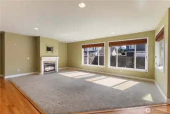 The home features an open floor plan with window coverings, heat pump to keep the home a comfortable temperature year-round, and hardwood floor in the kitchen, separate eating area, entry and hall.