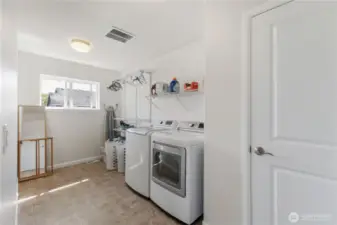 The upstairs utility room features a large linen closet, extra shelving, plumbed for a utility sink and ability to have more than one dryer!