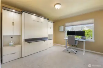 The fourth bedroom offers flexibility with a built-in Murphy bed—perfect for guests or a home office setup. A large closet provides ample storage, while built-in display shelves add both function and charm.
