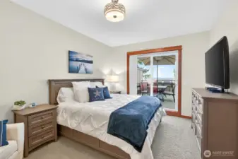 Large primary bedroom with with outside access and water views!