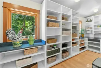 Substantial Walk-through Butler's Pantry with windows, located behind oven.