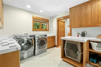 Laundry area boasts a High Capacity Washer and Dryer, Utility sink, lots of storage and a Built-in Nook for a large dog crate.