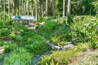 Pathway over bridge to covered dog kennel (maybe chicken coop?).