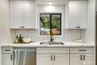 From the kitchen sink, enjoy direct views of the Narrows Bridge and Olympic Mountains.