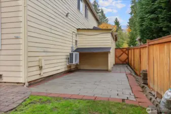 Even more patio space with some covered storage - AC pictured
