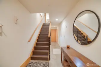 Entry leading to the lower bedroom, utility room, and access to the garage