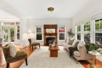 Large living room just off the entry featuring charming gas fireplace.
