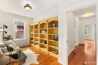 Another view of the sitting room with built in shelves, maybe an office or craft area?