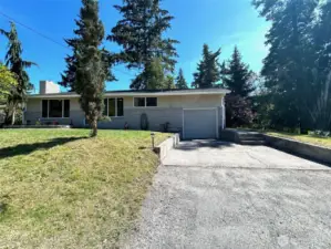 front view of home, including driveway into garage