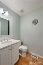 A conveniently located powder room is situated on the main level for guests and everyday use.