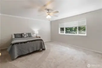The spacious primary suite offers serene views of the lush backyard, creating a private retreat you'll love coming home to.