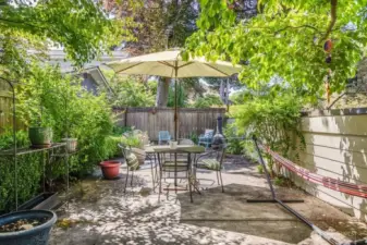 The private patio tucked up a few stairs, next to the southern carport, is a perfect spot to unwind, explore your green thumb, BBQ, or entertain friends.