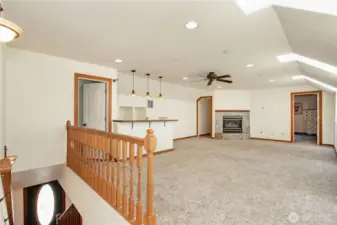 Upstairs Living Space W/ A Bar And Fireplace