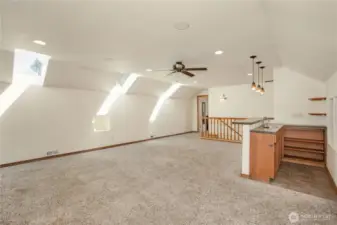Upstairs Living Space W/ A Bar. Natural Lighting From The Skylights