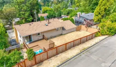 Host a BBQ for friends on this large deck and fenced yard.  Access to east side of property is available from this street, 95th Pl.