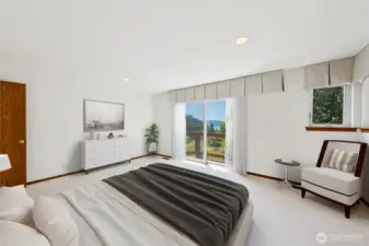 Primary bedroom on the main level with deck access and large ensuite.  Virtually staged.