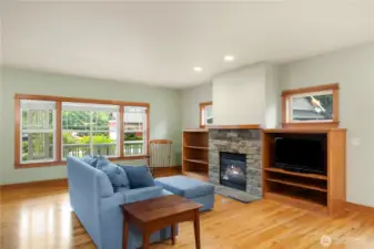 Built in shelves and windows set off the fireplace.