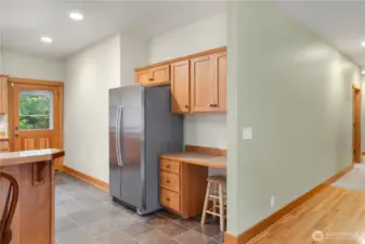Handy desk area in kitchen. Door to deck in background.