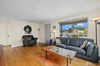 Living room showcasing natural light and flow to bedrooms