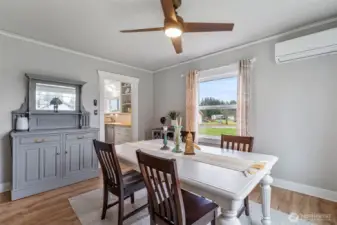 Stepping through to the dining room. Sooo cute! Notice the ductless wall heater providing energy-efficient heating and cooling to the home.