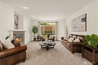 Large living room with gas fireplace, connecting you to the backyard