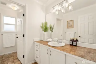 Upstairs bathroom with amazing counter space and a separate door for the shower & commode