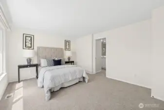 Another look at the primary suite and its connection to the attached, three-quarter bath.