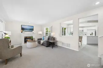 The spacious living room is open to the kitchen and has two large, sunny windows and a gas fireplace. All new carpeting throughout the home!
