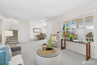 Another look at the living room and its connection to the stairs, entry, and dining room. That window overlooks the front porch.