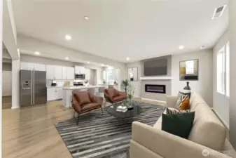 Gourmet kitchen with large center island, quartz counters, loads of cabinets, built-in 48" fridge and in-wall oven & microwave next to your large family room. Actual home is under construction and materials, colors, and finishes will vary. See site agent for details.