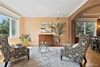 The living room is inviting with warm paint tones, hardwoods and an extensive white millwork package and crown molding that is abundant throughout the home. Living room opens to a grand dining room ideal for entertaining.