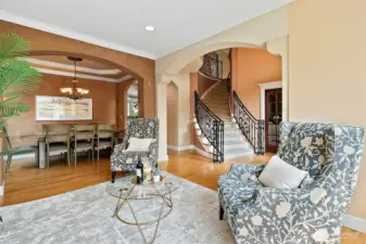 A great view of both the living and dining room showcasing the arched entries and Venetian Plaster walls.