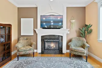 Family room is a true focal point, featuring floor-to-ceiling custom built mantel with a tv niche and a propane fireplace that adds warmth and ambiance.