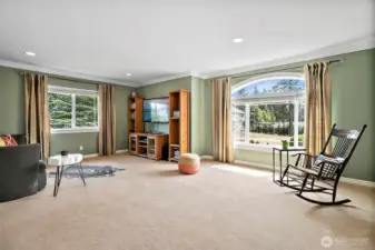 Spacious upstairs bonus room with large arched windows fill this space with natural light. This room is ideal for movie nights, games or as a potential home office or guest suite.  Adjacent to the bonus room is a versatile spare room, perfect for storage, craft room or hobby space.