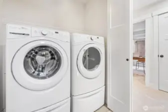 Full-size washer and dryer on upper level.
