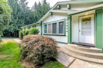 Entry with mature landscaping and Japanese Maple