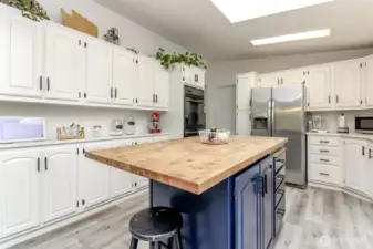 Bright kitchen features skylights, large island and tons of storage!