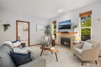 Family room with gas fireplace, overlooking private back deck. Mainfloor den on other side of family room.